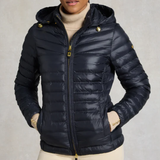 Navy puffer jacket worn by a person on a neutral background