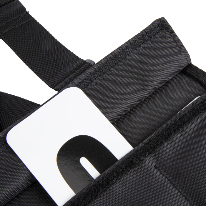 Close-up of a black vest with a visible brand logo on a white background