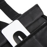 Close-up of a black vest with a visible brand logo on a white background