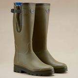 Pair of light green wellies on a beige background
