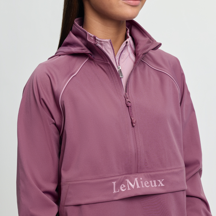Pink waterproof jacket with LeMieux branding on a white background
