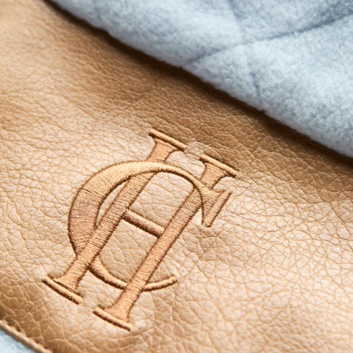 Brown leather material with HC logo and blue fleece