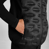 Close-up of a black gilet with pockets on a grey background