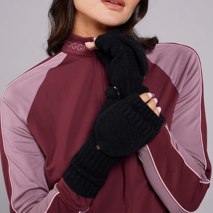 Person wearing a maroon and pink outfit with black gloves on a grey background