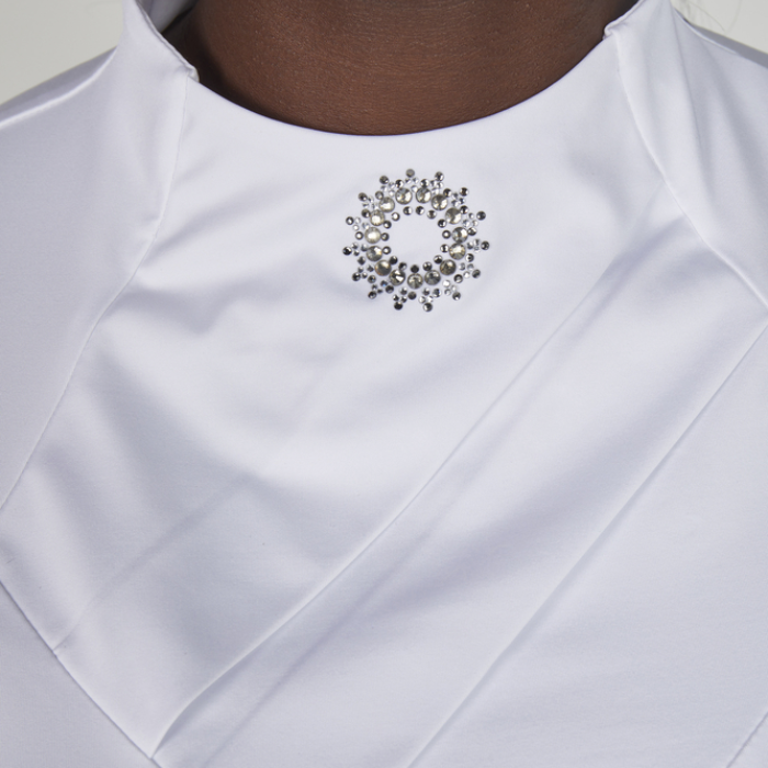 White shirt with diamante collar brooch and ruffles on a white background