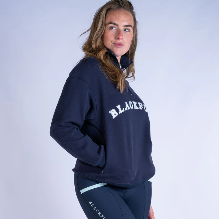 Person wearing a navy blue sweatshirt with 'BLACKFORT' branding on a light grey background