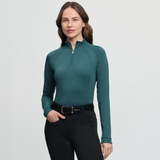 Woman wears green base layer with quarter zip on a white background