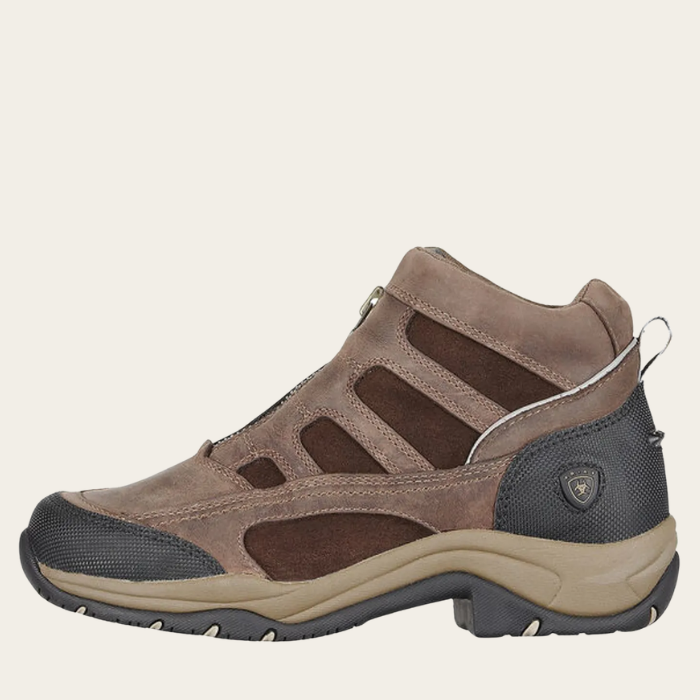 Brown and black hiking shoe on a beige background