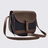 Brown and navy leather crossbody bag on a light grey background