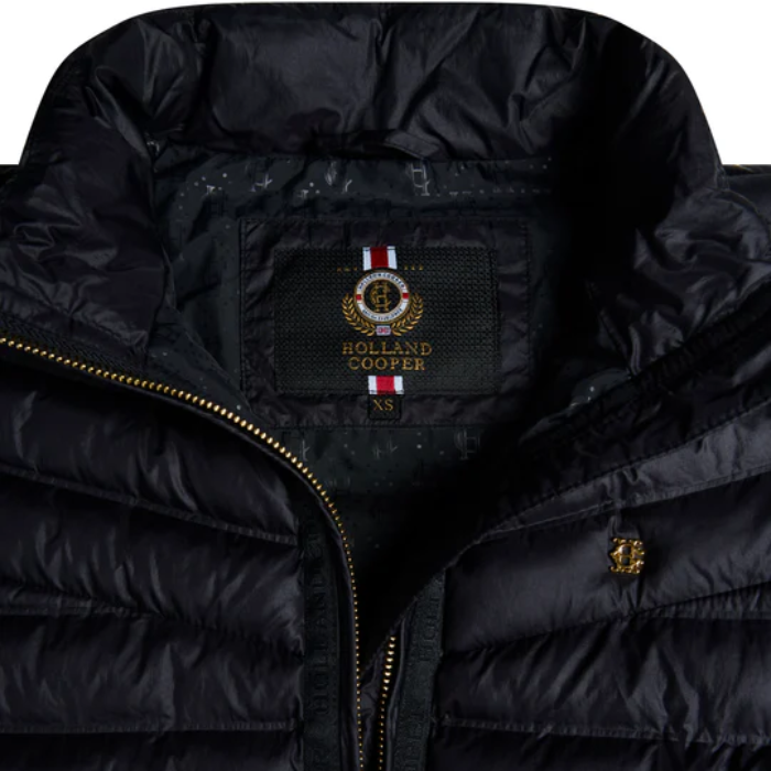 Navy puffer jacket with Holland Cooper logo on a white background