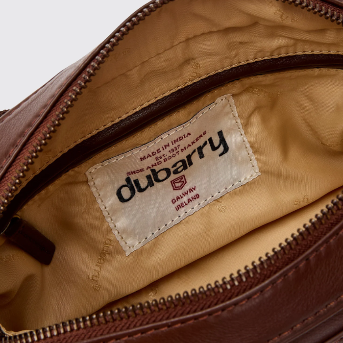 Brown leather bag with Dubarry label on a white background