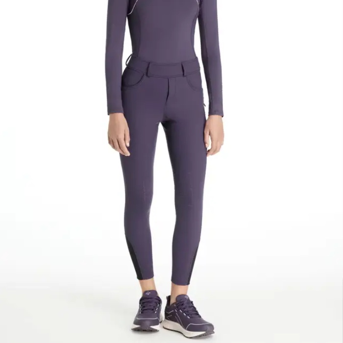 Person wearing purple riding leggings on a white background
