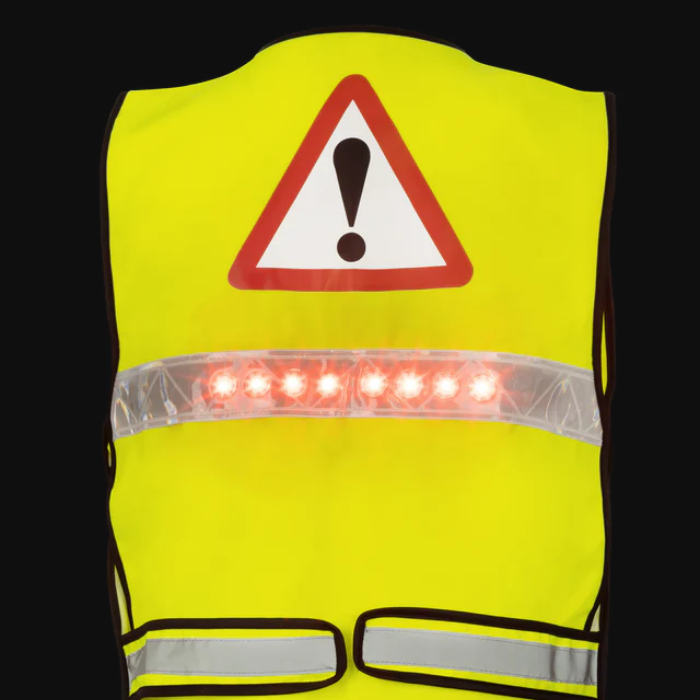 Yellow safety vest with reflective stripes and a warning triangle on a black background