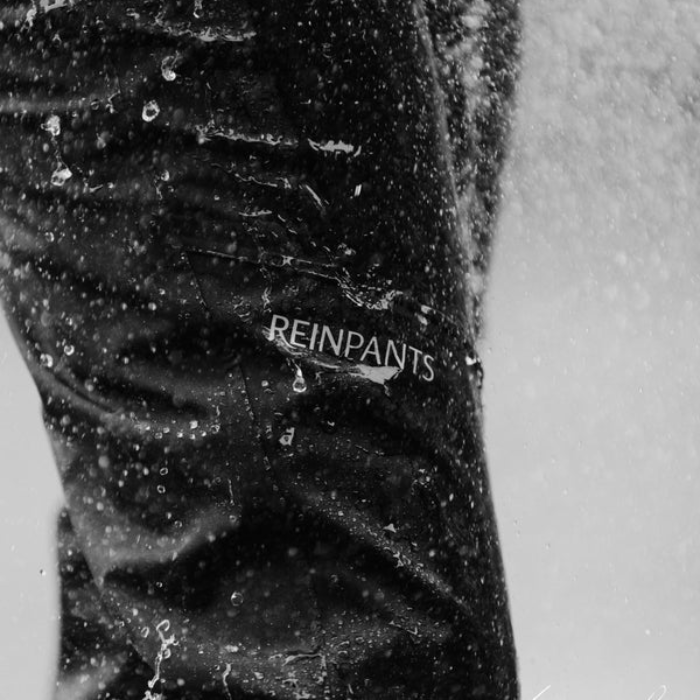 Close-up of a waterproof material with 'REINPANTS' branding.