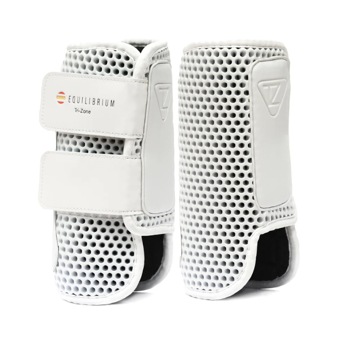Pair of white horse leg protective boots with Equilibrium branding on a white background