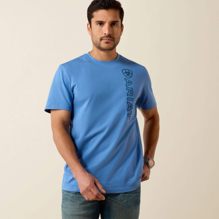 Man wearing a blue t-shirt with a logo on a beige background