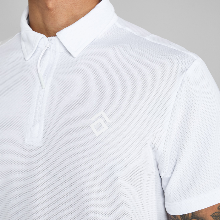 White polo shirt with a small logo on a neutral background