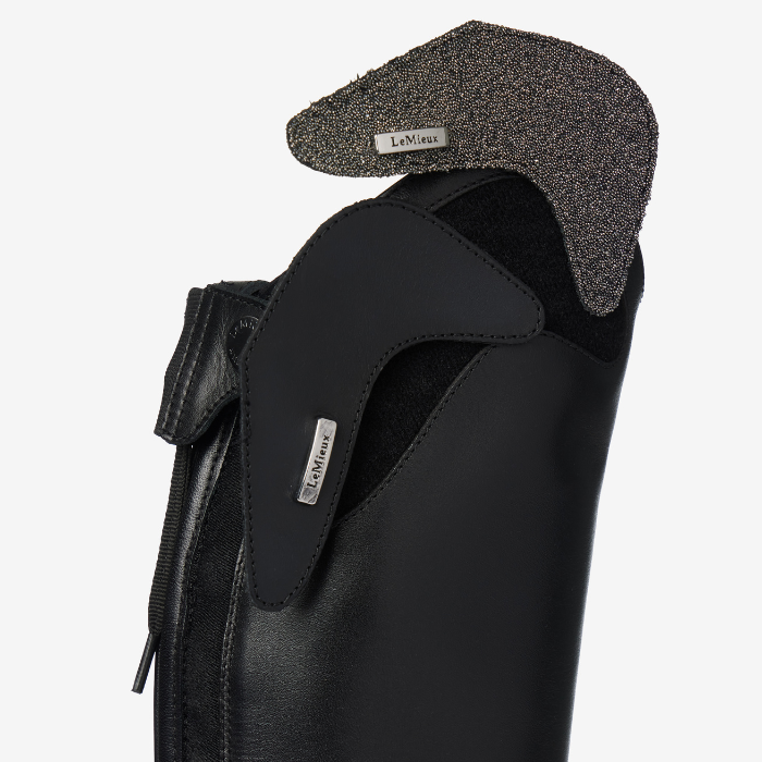 Black riding boot with removeable sparkle element on a white background