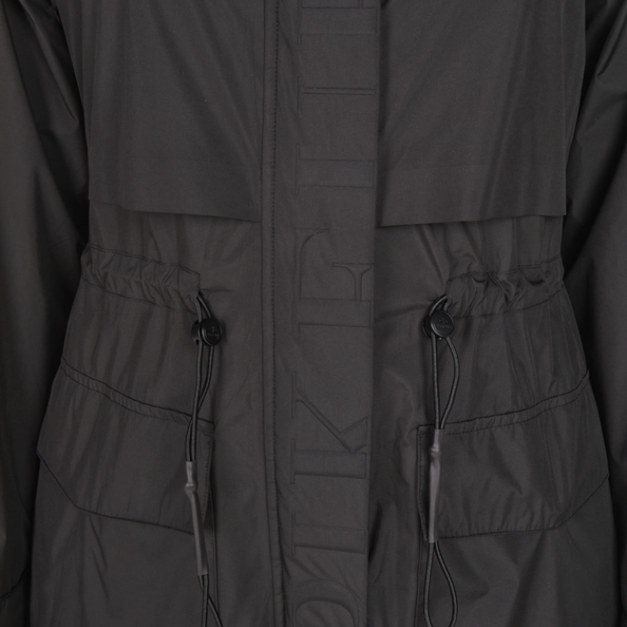 Close-up of a dark black jacket with drawstrings and buttons.