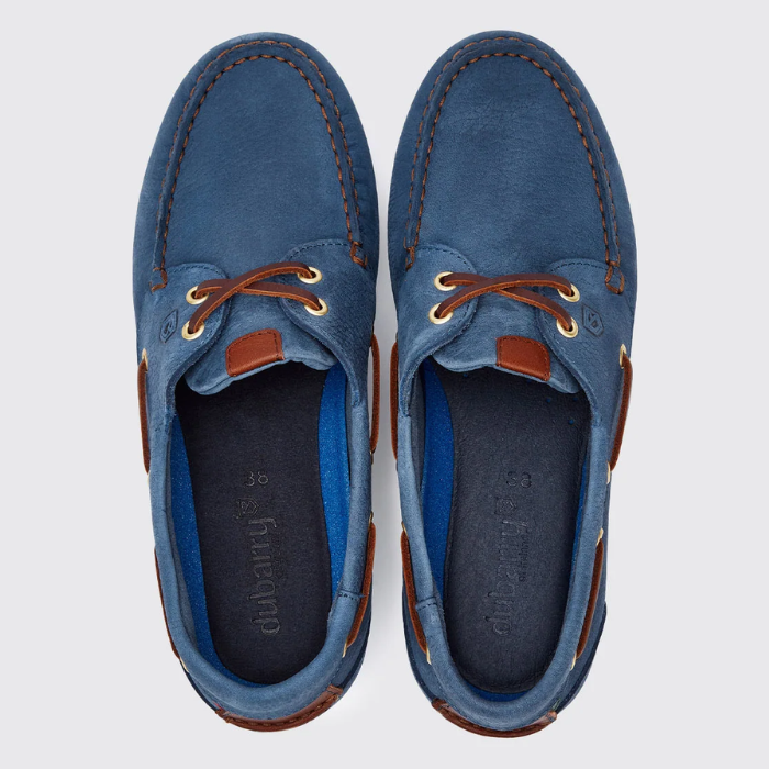 Pair of blue suede shoes with brown accents on a light grey background