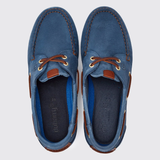 Pair of blue suede shoes with brown accents on a light grey background