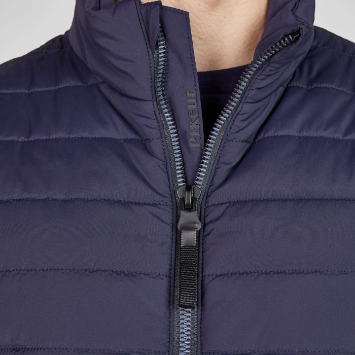 Navy blue puffer gilet with a zipper on a light grey background