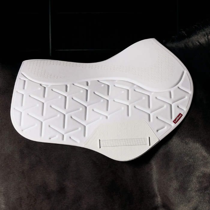 White saddle pad with geometric pattern on a dark background