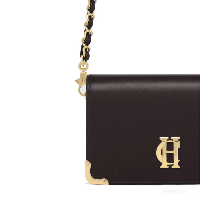 Black handbag with gold accents on a white background