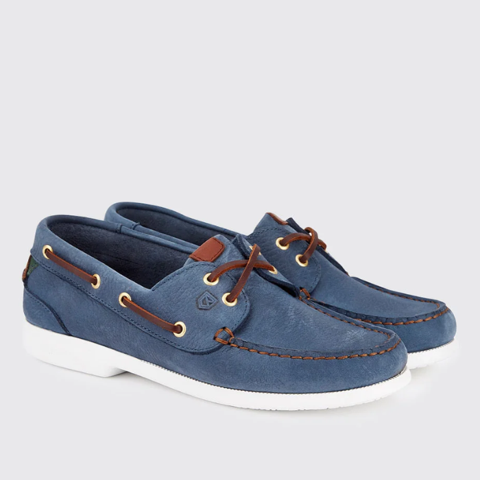 Blue suede boat shoes with brown laces on a light grey background