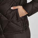 Close-up of a person wearing a black puffer jacket with a neutral background