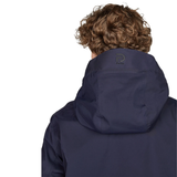 Person wearing a navy blue jacket with a brand logo on a white background