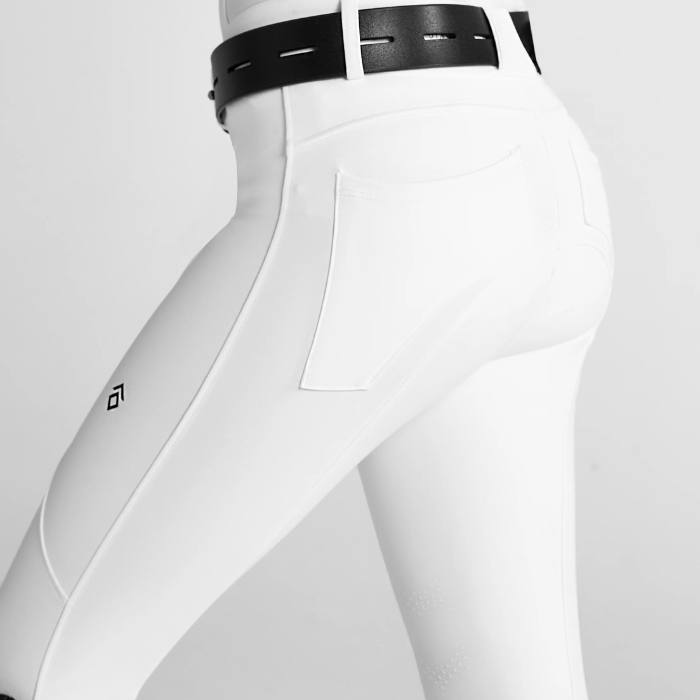 Close-up of a pair of white riding breeches with diamond logo design on a grey background