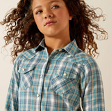 Person wearing a blue plaid shirt against a neutral background
