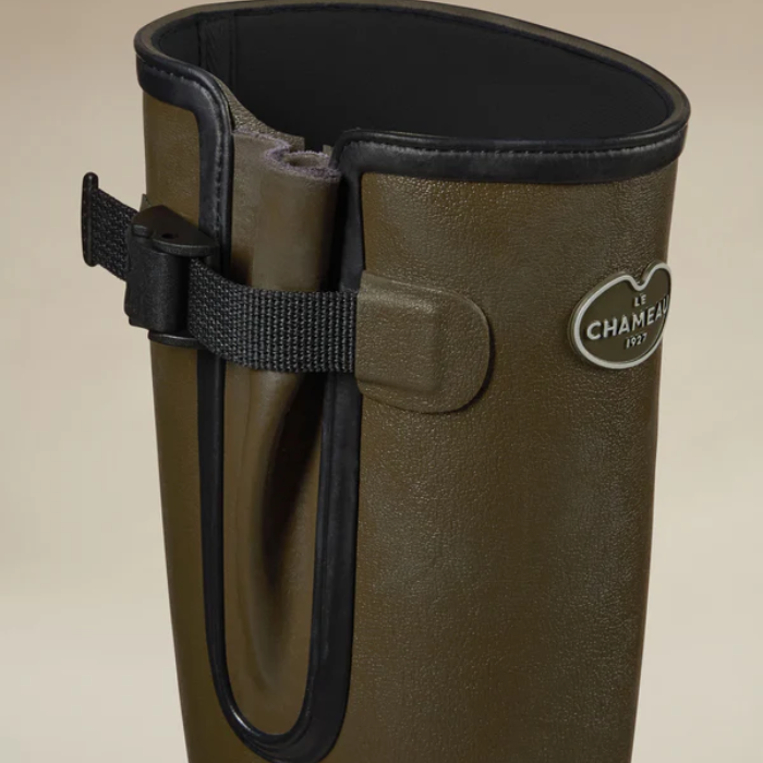 Close up of a pair of wellington boots with Le Chameau branding against a neutral background