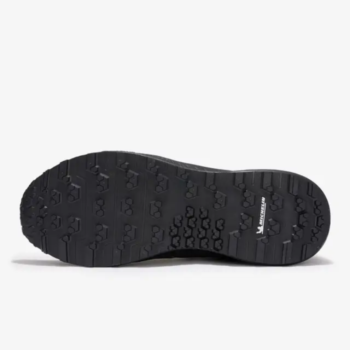 Black shoe sole with tread pattern on a white background