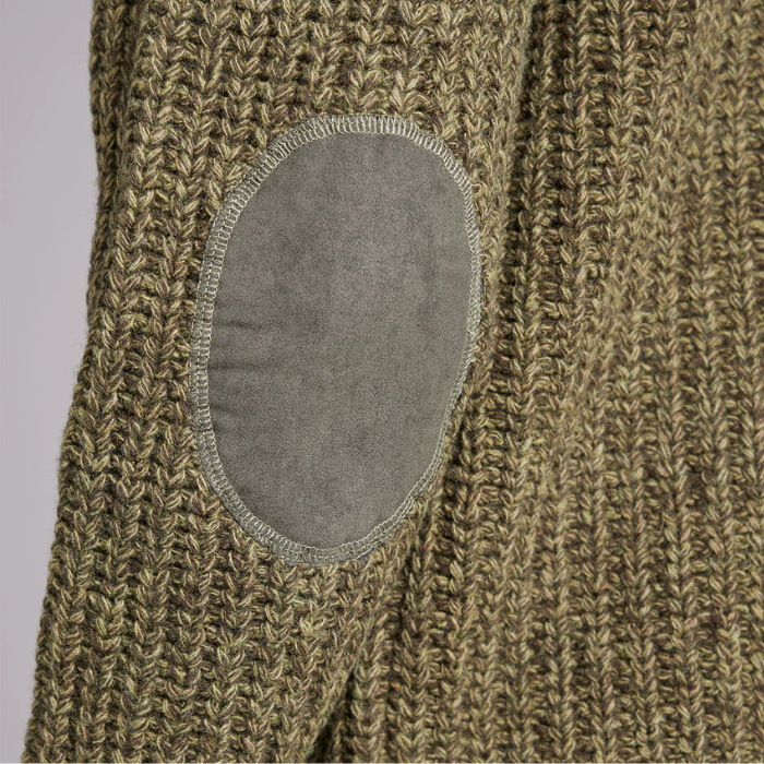 Close-up of a green knitted garment with an elbow patch on a grey background