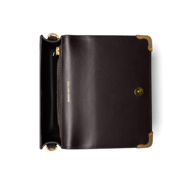 Black leather clutch with gold accents on a white background