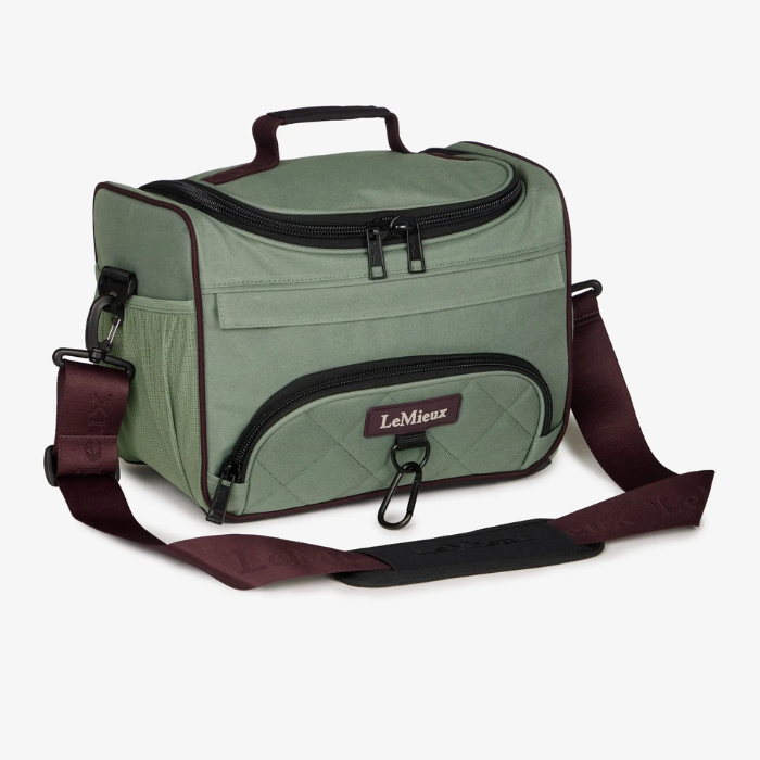 Green bag with brown strap and visible brand logo on a white background