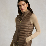 Woman wearing a brown puffer gilet on a plain background