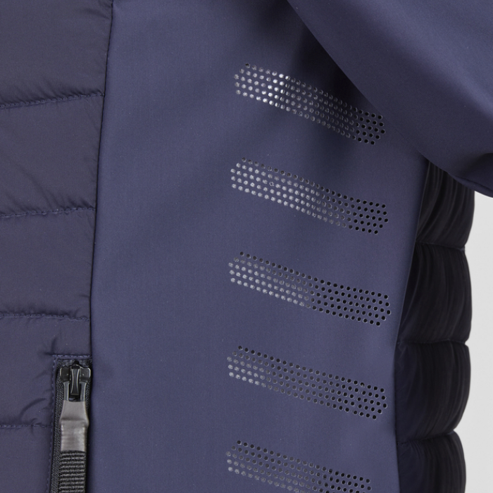Close-up of a blue jacket with perforated patterns on a grey background