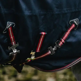 Belly straps close-up on a navy turnout rug