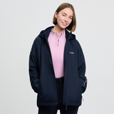 Woman wears a navy jacket and pink base layer on a white background