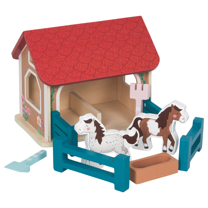 Toy stable with horses and accessories on a white background