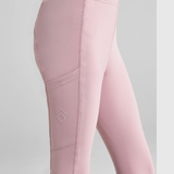 Close-up of pink riding leggings with diamond brand logo on pocket and a grey background