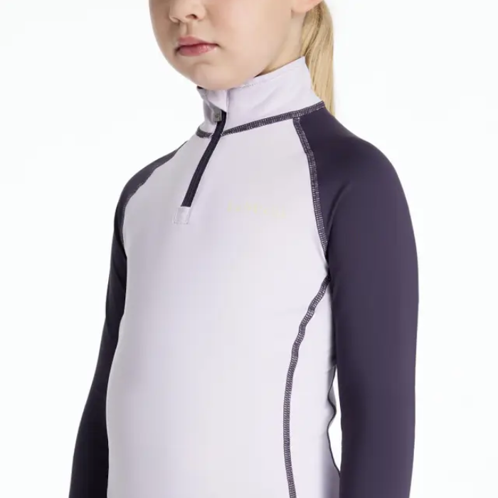 Child wearing a lilac and purple long-sleeve shirt with a zipper on a white background