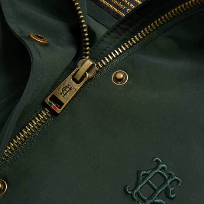 HC zipper detail on dark green fabric