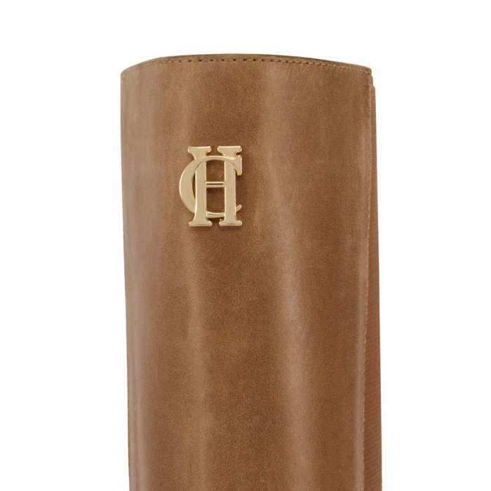 Brown leather boot with a gold HC logo on a white background