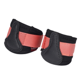 Pair of black and pink protective equestrian leg wraps on a white background