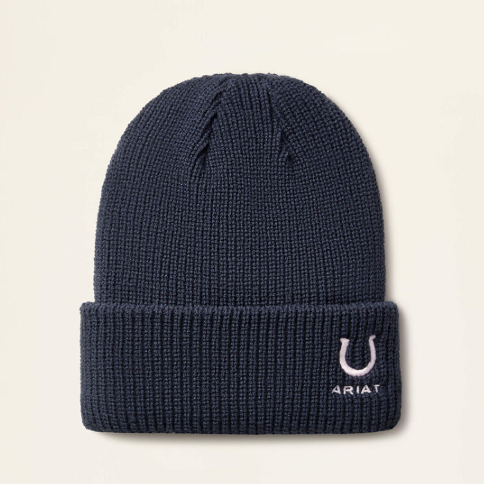 Navy beanie hat with horseshoe emblem and ARIAT branding on a beige background