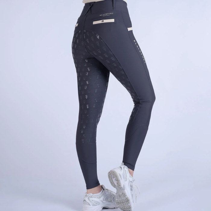 Dark grey leggings with sand elements on a grey background
